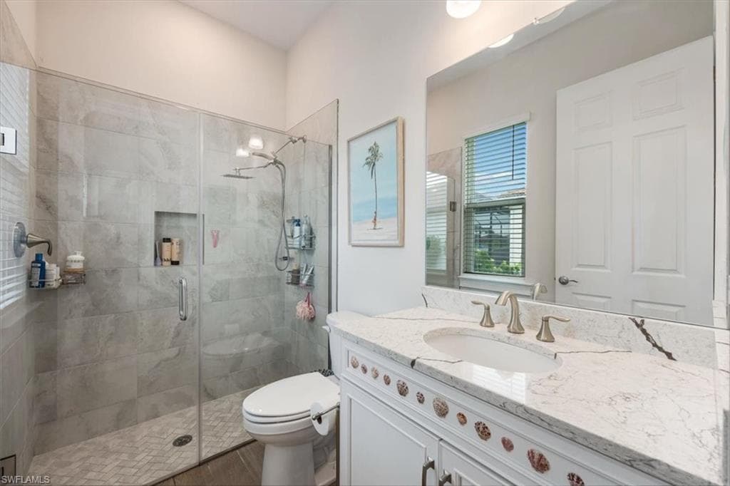 Full bath featuring vanity and a stall shower