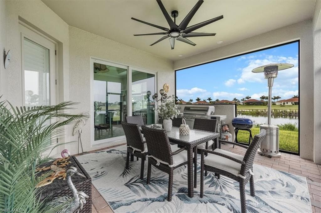 Sunroom / solarium featuring a water view
