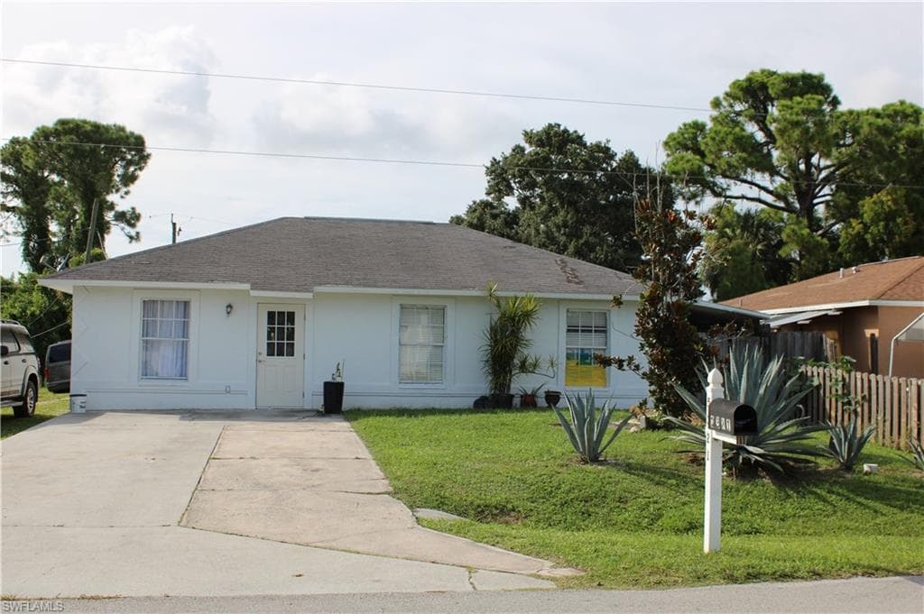 Single story home featuring concrete driveway, stucco siding, and a shingled roof