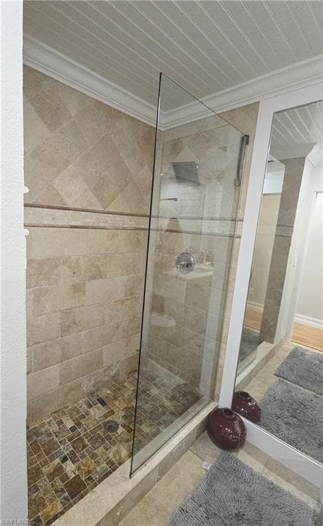 Full bath featuring walk in shower and crown molding