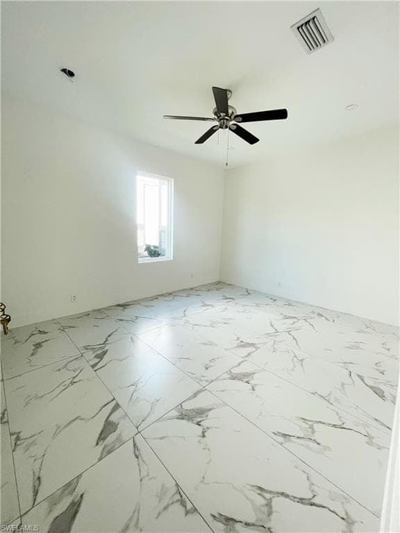 Unfurnished room featuring a ceiling fan