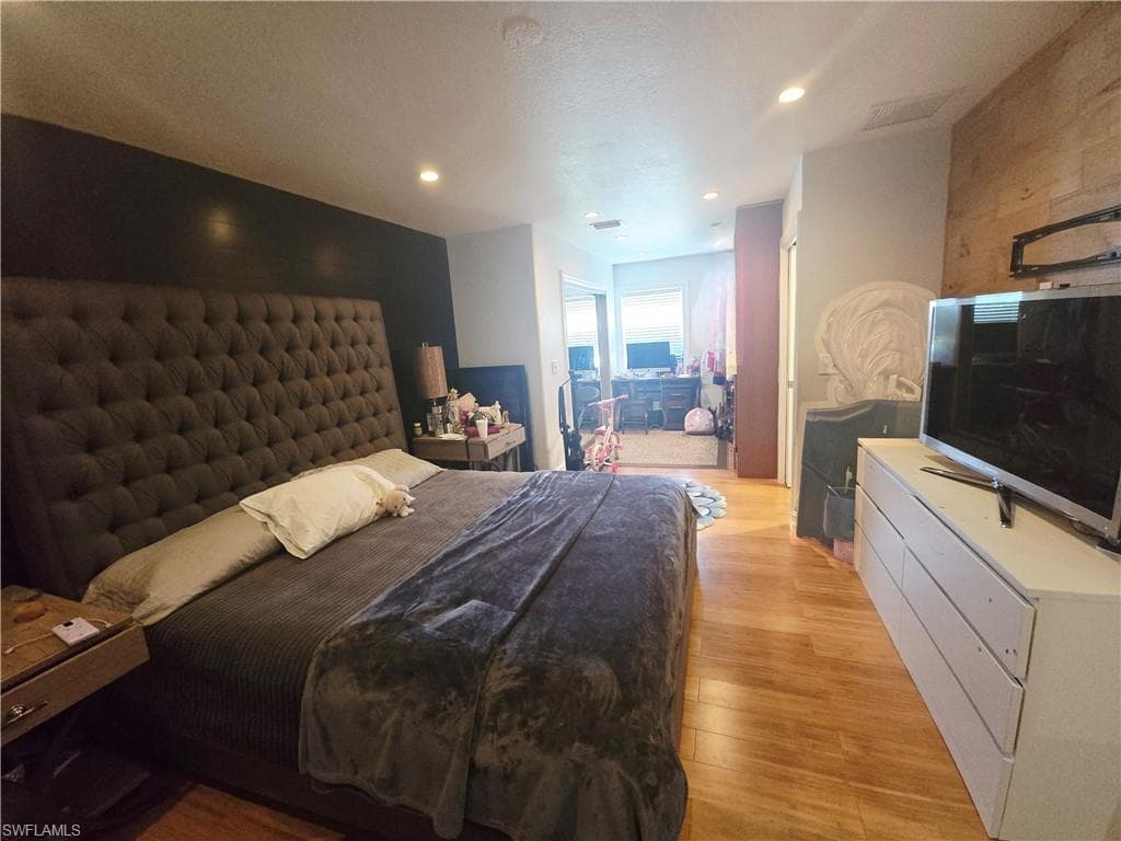 Bedroom featuring light wood-style floors, recessed lighting, and a textured ceiling