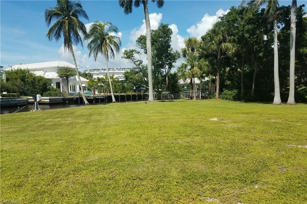 View of green lawn featuring a water view