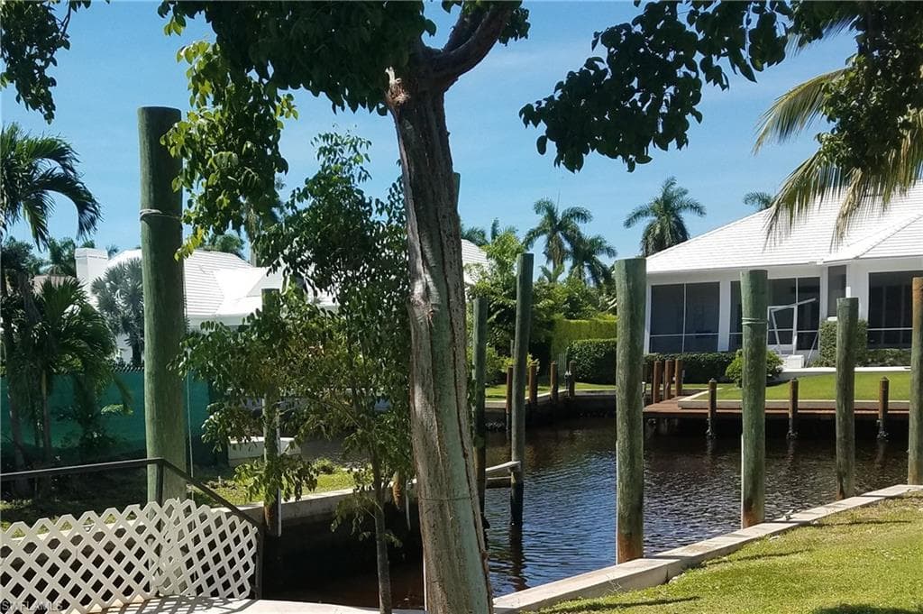 Dock area with a water view and a sunroom