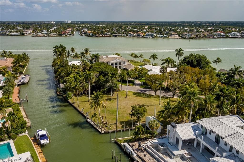 Aerial perspective of suburban area featuring a nearby body of water