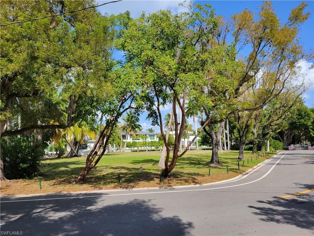 View of home's community with a lawn