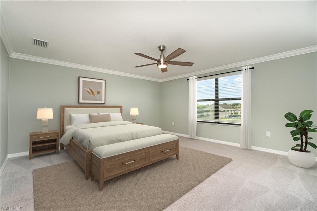 Bedroom featuring crown molding, light colored carpet, and a ceiling fan
