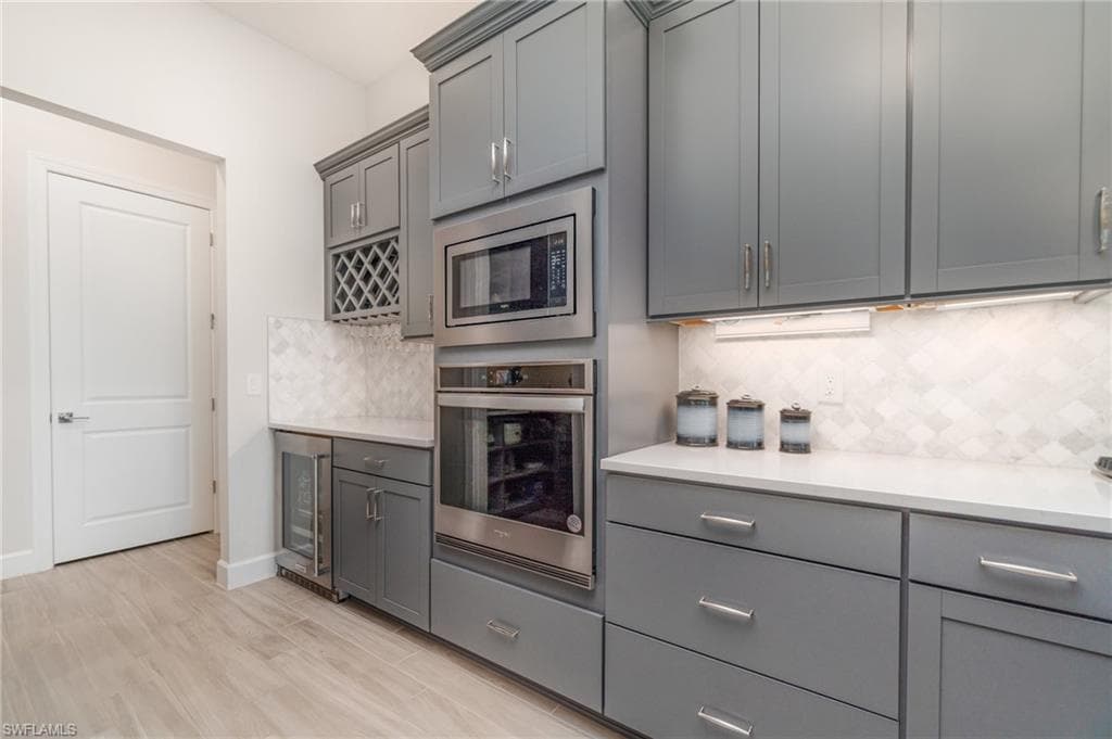 A true dream kitchen with 42" upper cabinets, roll out drawers and a beverage center perfect for entertaining! Have we mentioned the gorgeous flooring?!
