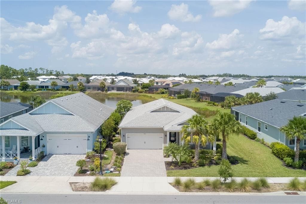 Aerial perspective of suburban area with a nearby body of water