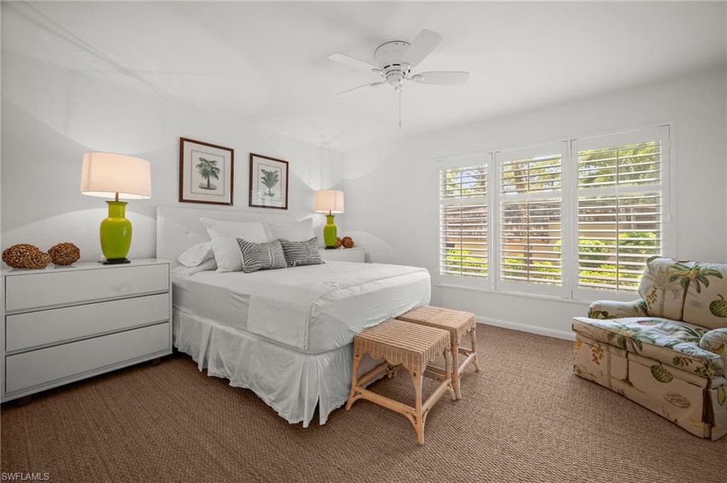 Guest bedroom 1 is en-suite with plenty of light and Bahama shutters for privacy!