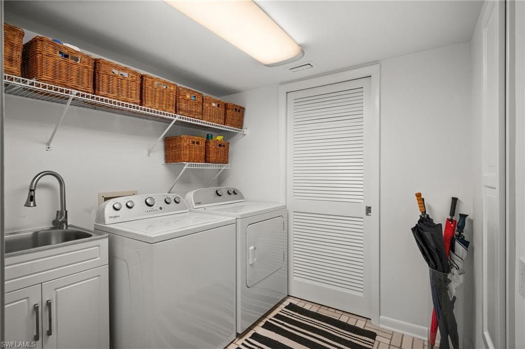 Washroom featuring independent washer, dryer and sink seperated by a lovered poclet door for the mechanicals!