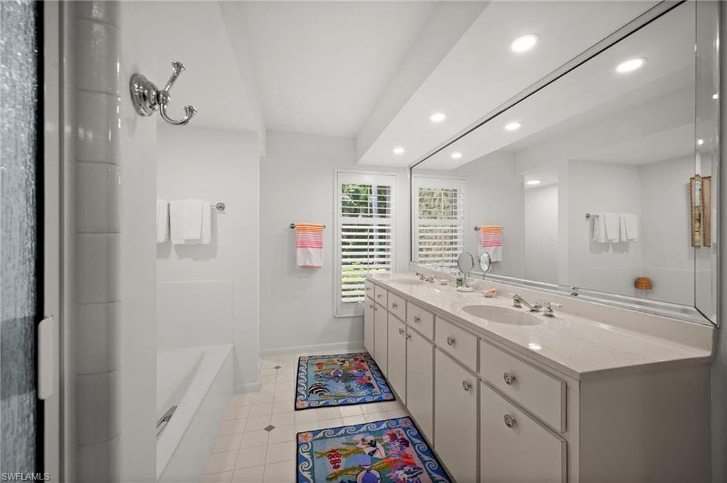 The light filled primary bathroom has a cast-iron soaking tub, separate shower and toilet areas, as well as a double sink vanity with plenty of storage!