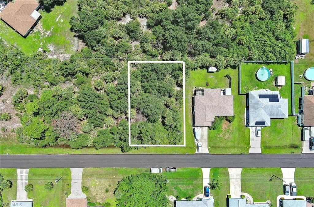Aerial perspective of suburban area featuring property parcel outlined