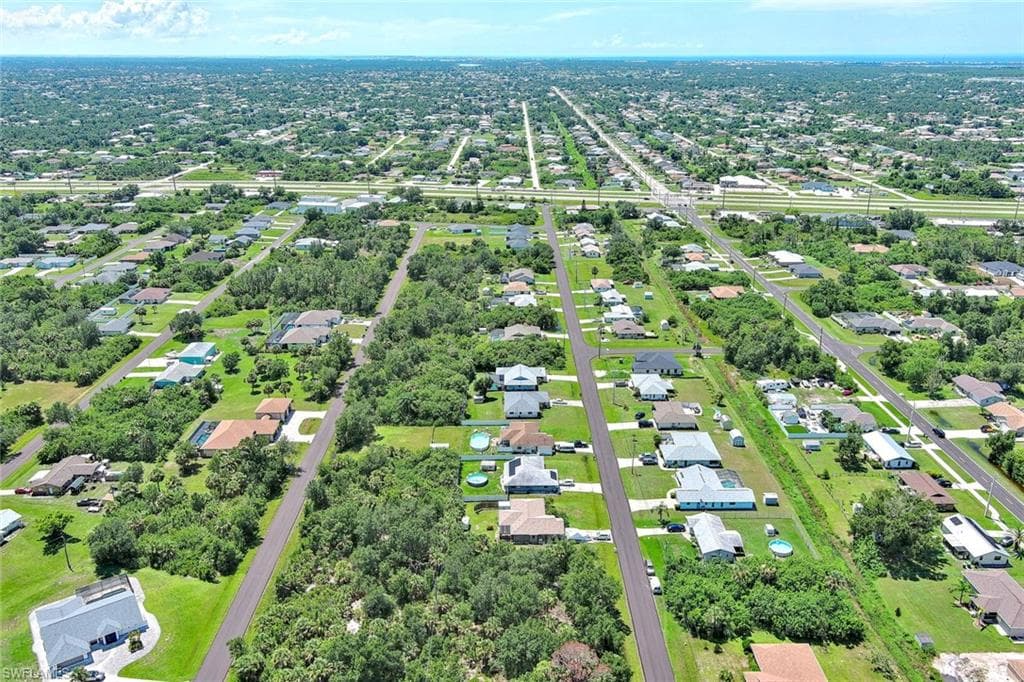 Aerial overview of property's location featuring nearby suburban area