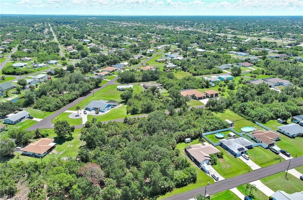 Aerial perspective of suburban area with a tree filled landscape