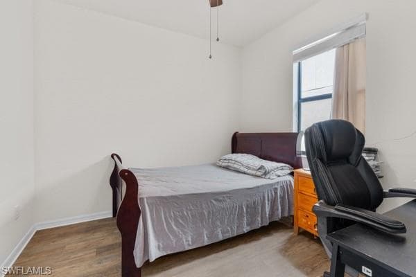 Bedroom with wood finished floors and ceiling fan