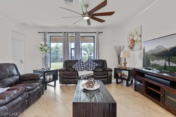 Living area featuring ornamental molding, ceiling fan, and light tile patterned floors