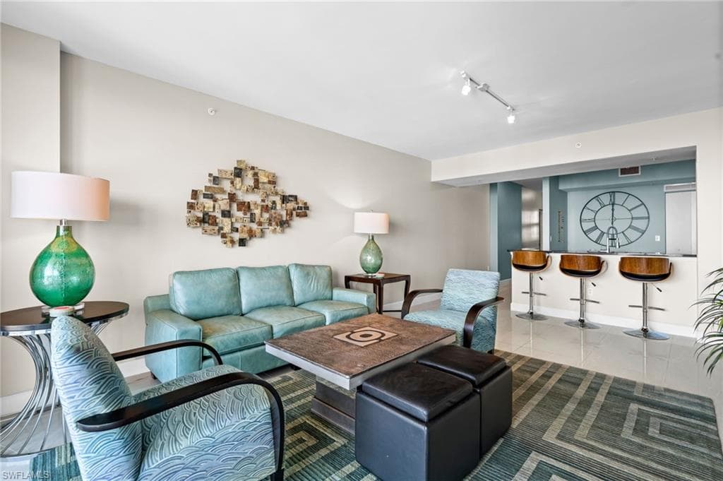 Living area with rail lighting and tile patterned floors