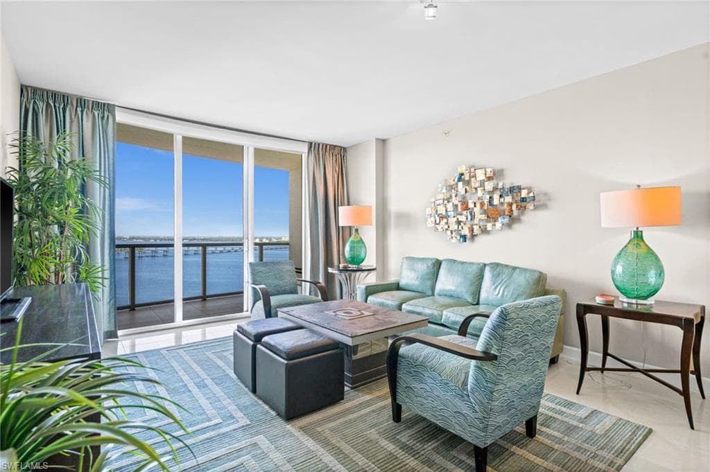 Living room with floor to ceiling windows and a water view
