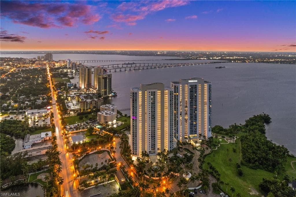 Aerial view of property and surrounding area with a large body of water