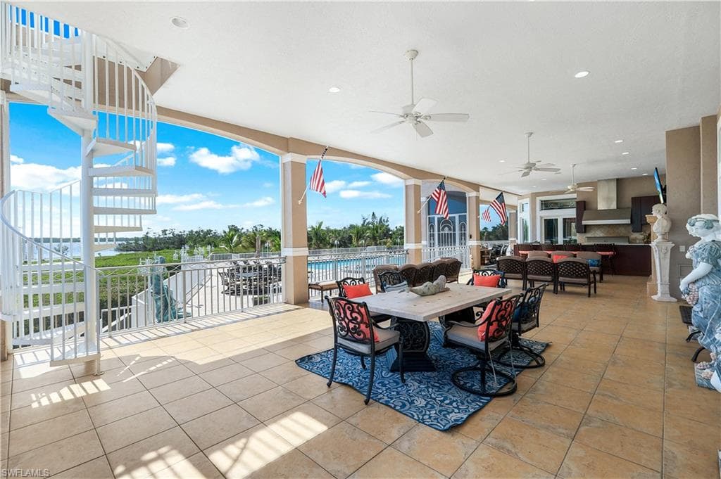 View of patio / terrace featuring an outdoor hangout area, stairs, outdoor dining space, and a ceiling fan