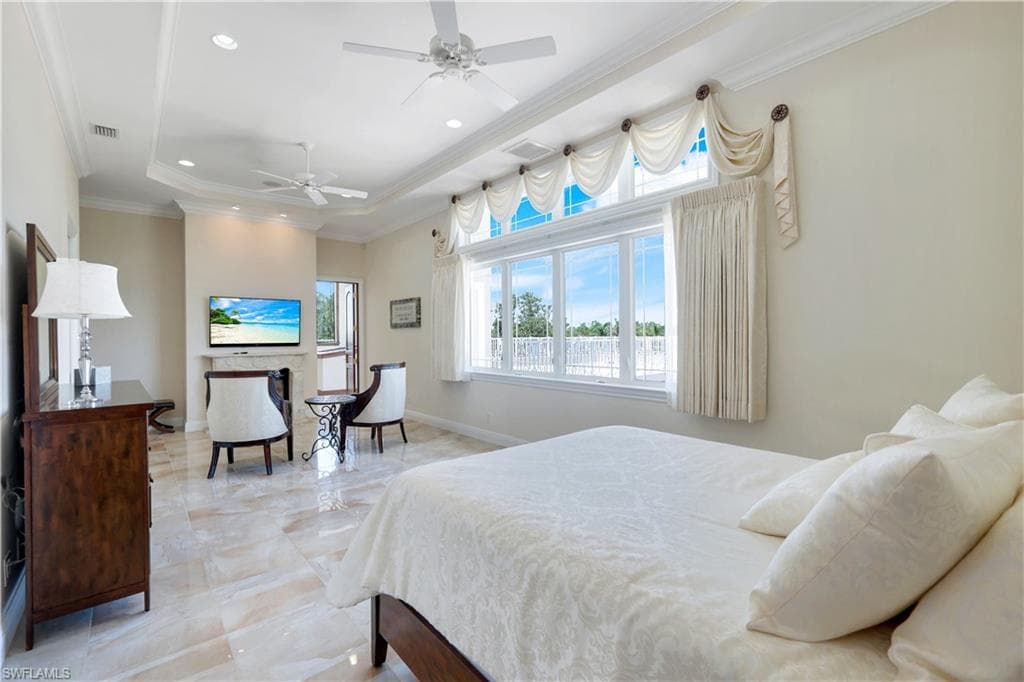 Bedroom featuring crown molding, a raised ceiling, recessed lighting, and ceiling fan