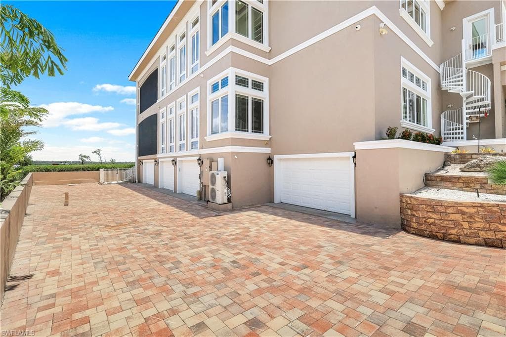 View of garage entry on the left side of the house. Garage doors are also on the right side of the house