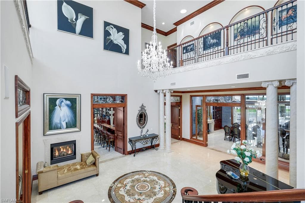 Common area featuring a high ceiling, ornamental molding, and recessed lighting