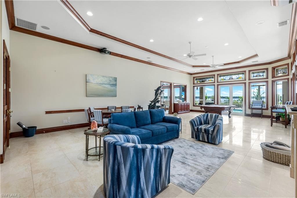 Living room featuring crown molding, billiards table, ceiling fan, a raised ceiling, and recessed lighting