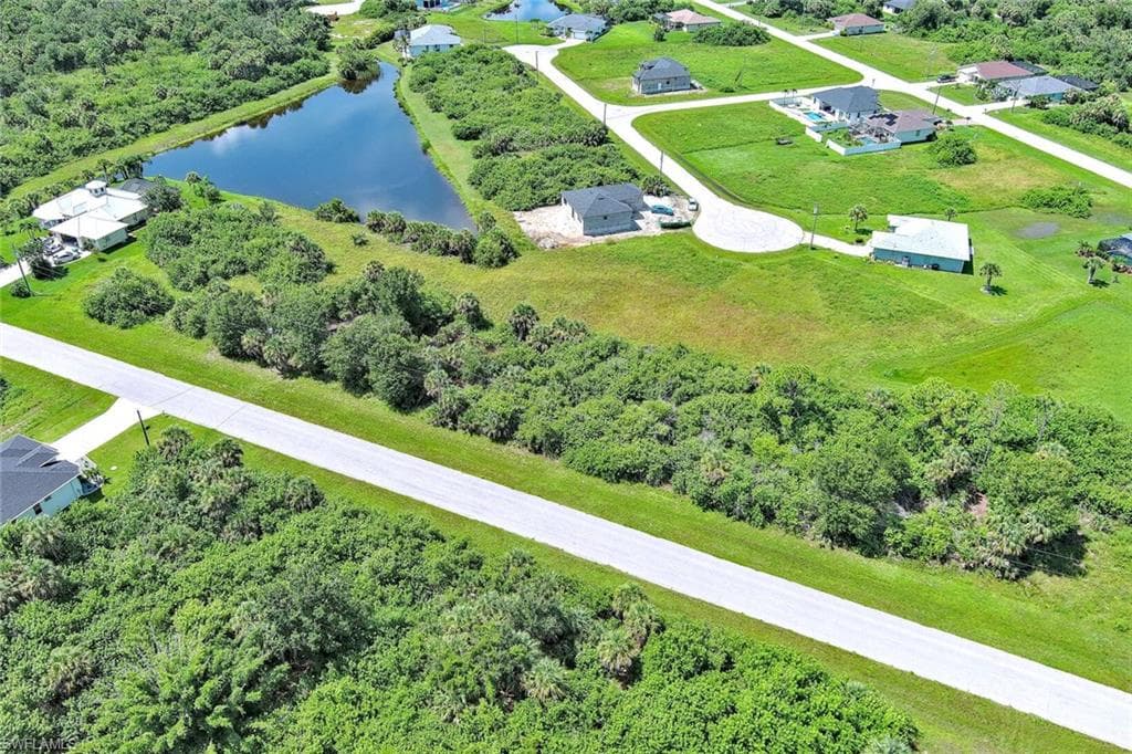 Aerial view of a nearby body of water and a tree filled landscape