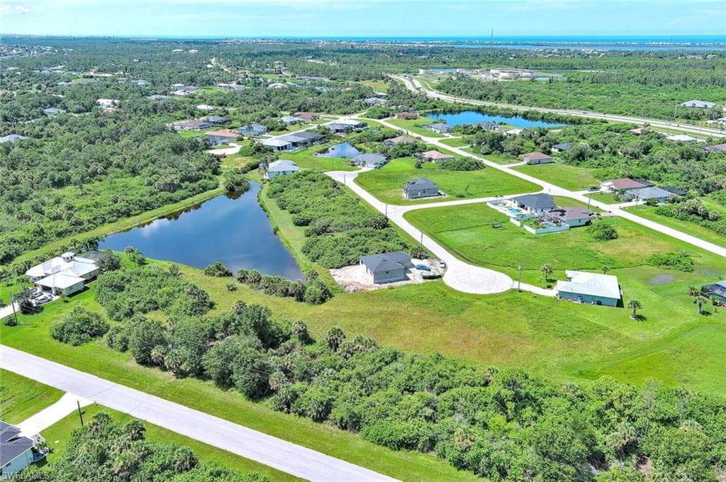 Bird's eye view of a nearby body of water and a tree filled landscape