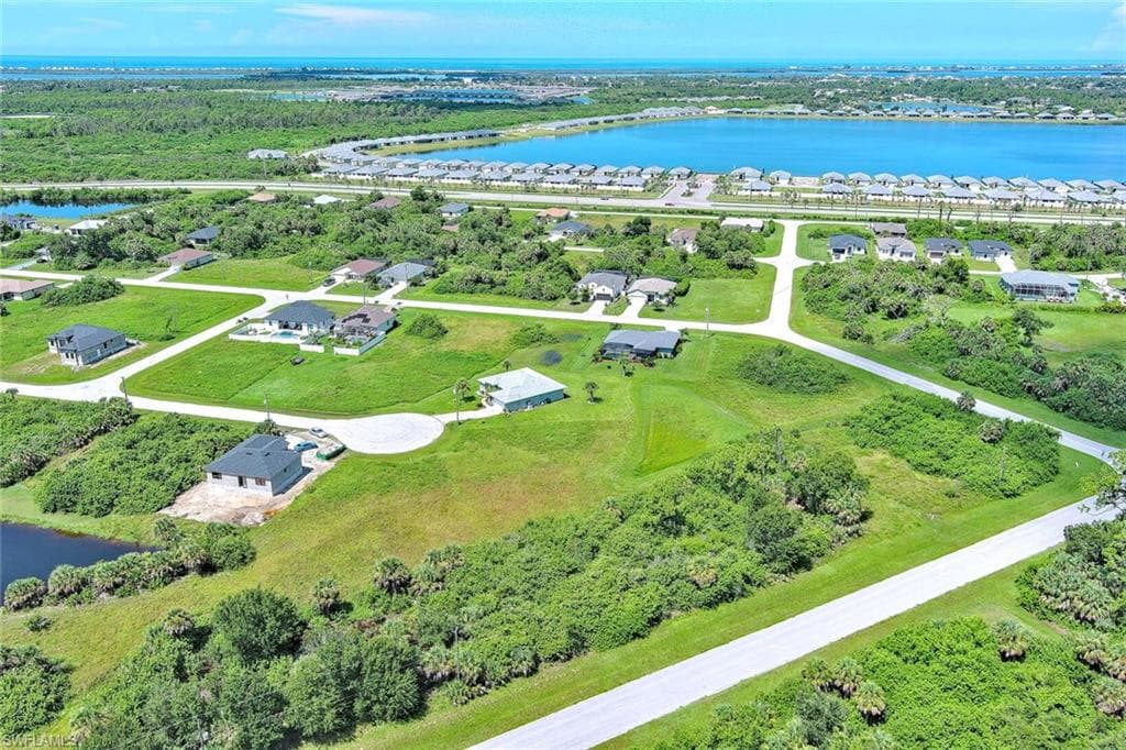 Aerial view of residential area featuring a large body of water
