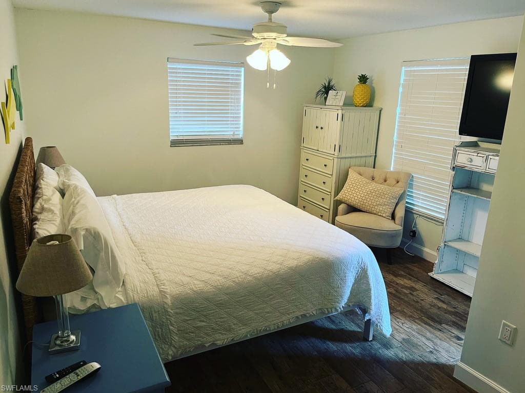 Bedroom featuring dark wood-style flooring and a ceiling fan