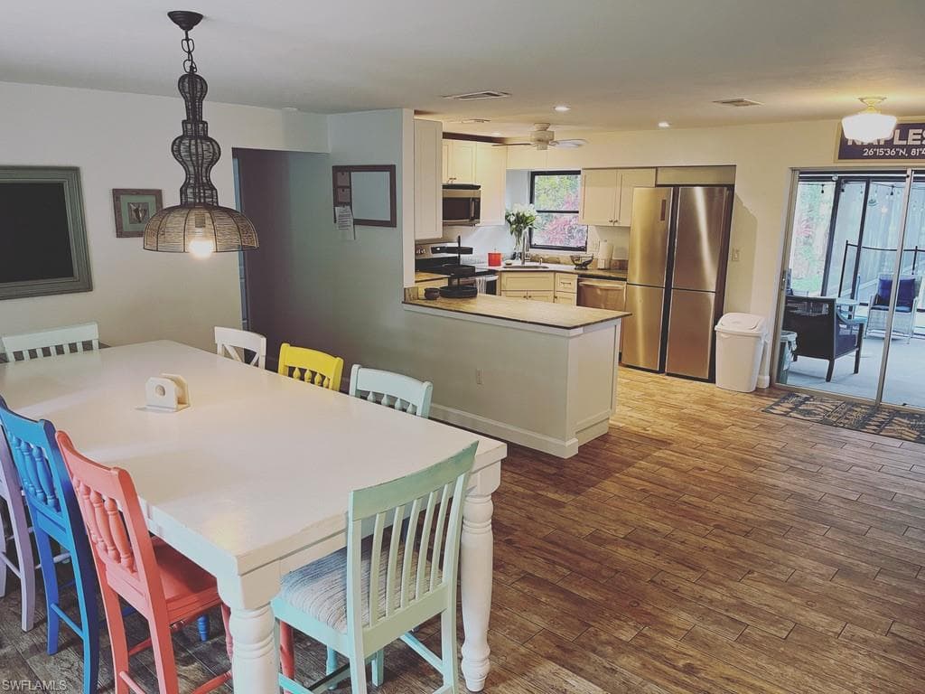 Dining space featuring dark wood finished floors and recessed lighting