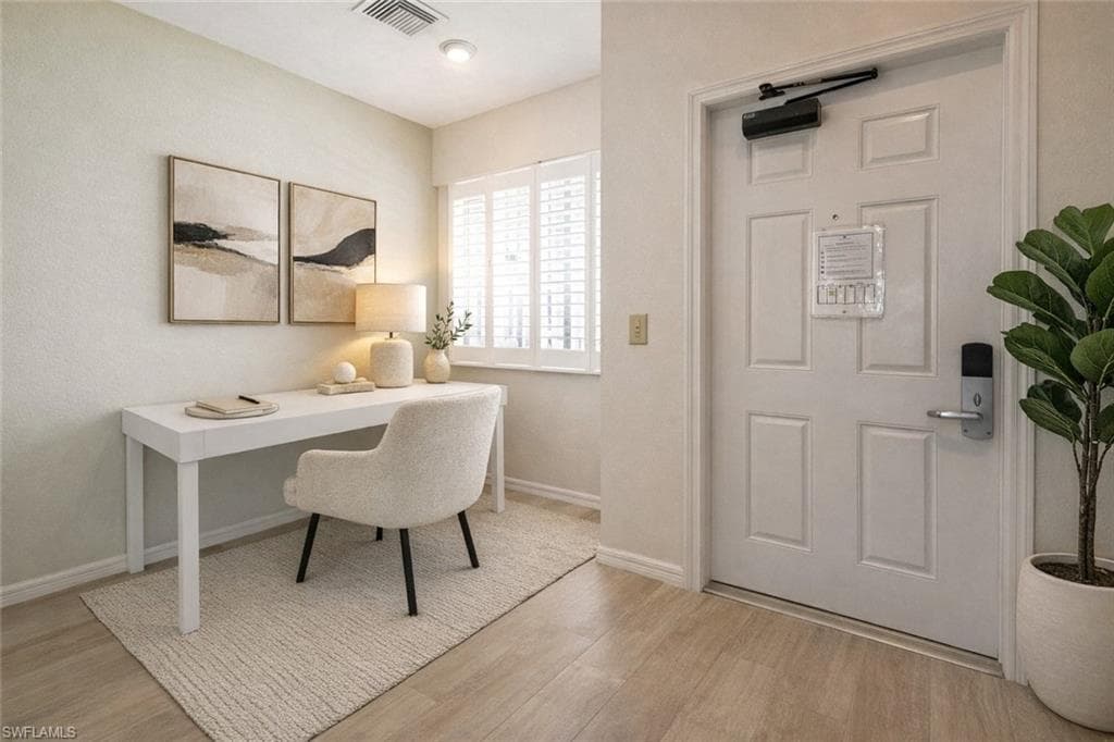 Virtual staged office space with light wood finished floors