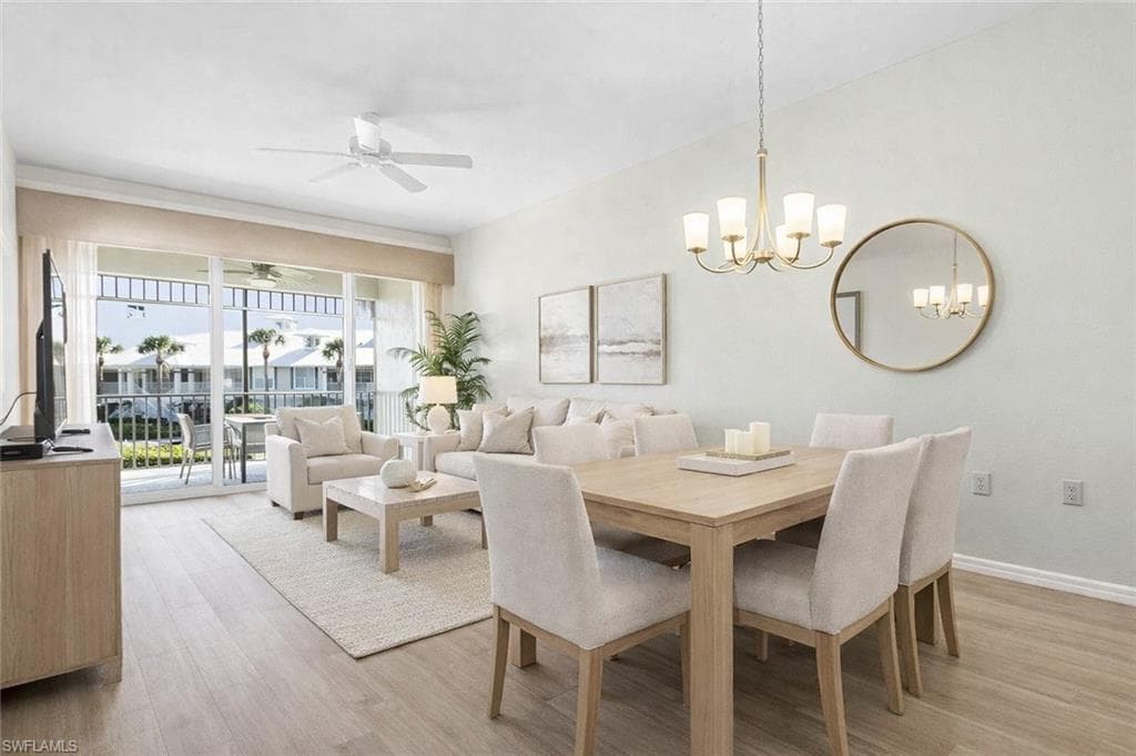 Virtual staged dining space with light wood-style flooring, ceiling fan, and suspended lighting