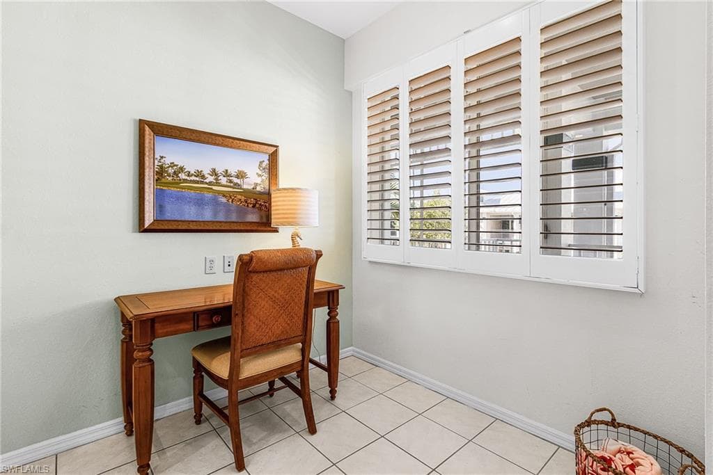 Home office with baseboards and light tile patterned flooring