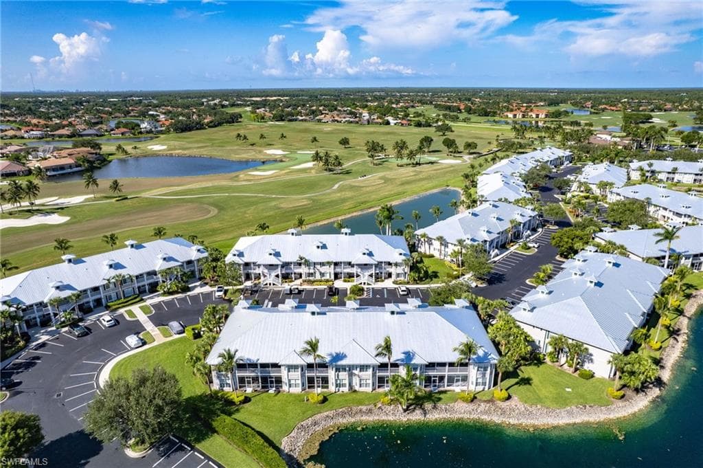 Aerial overview of property's location featuring a large body of water, a golf course, and nearby suburban area
