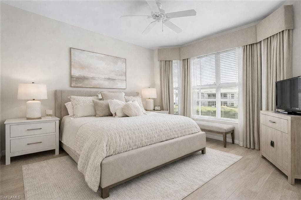 Virtual staged bedroom with ceiling fan and light wood-type flooring