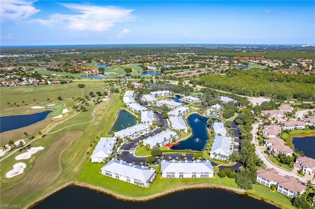 Aerial view of property's location featuring a large body of water and nearby suburban area