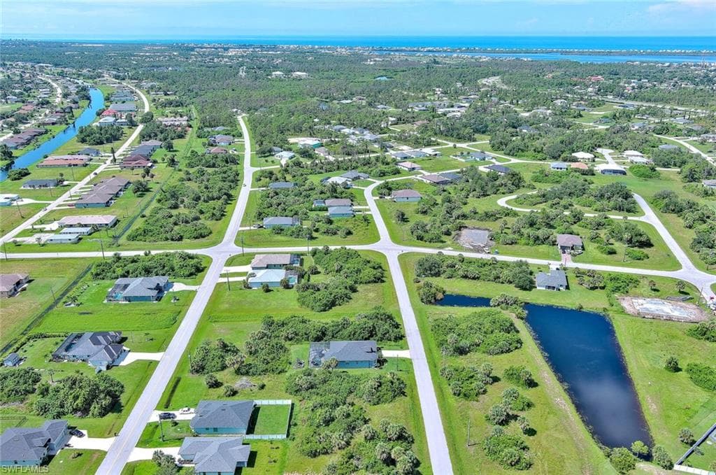 Aerial perspective of suburban area with a nearby body of water