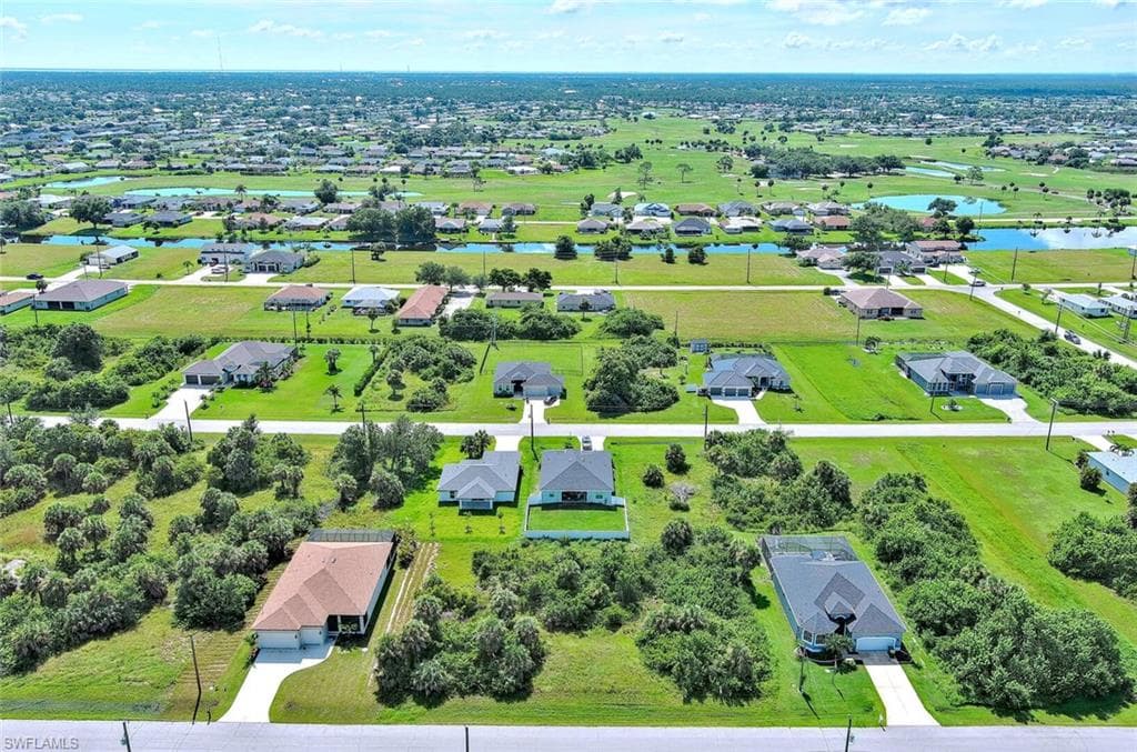 Aerial view of residential area featuring a large body of water