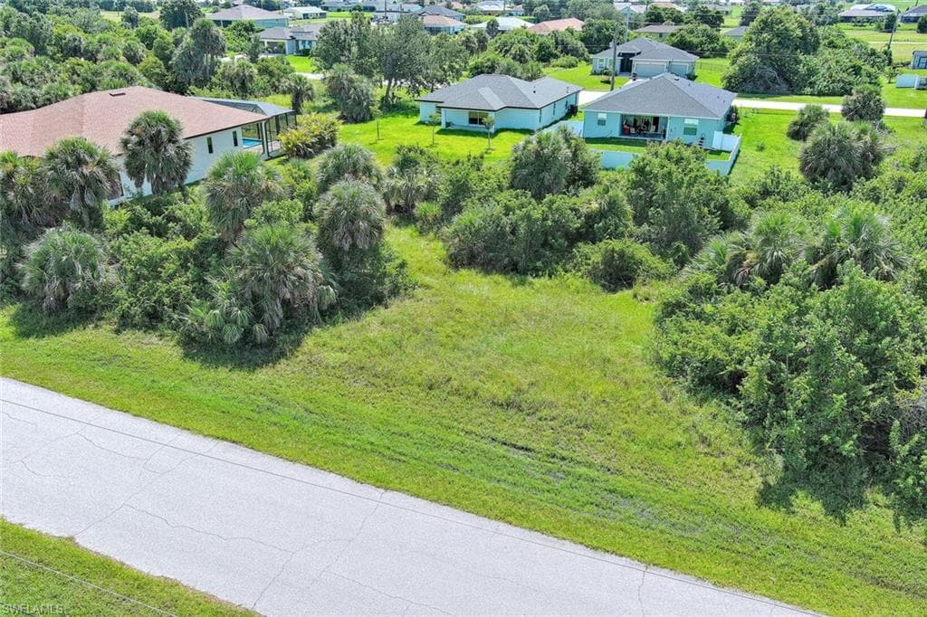 Aerial view of residential area featuring a tree filled landscape