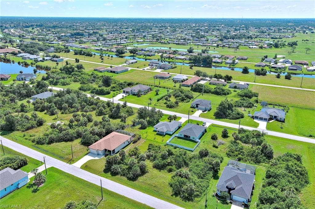 Aerial view of residential area featuring a nearby body of water