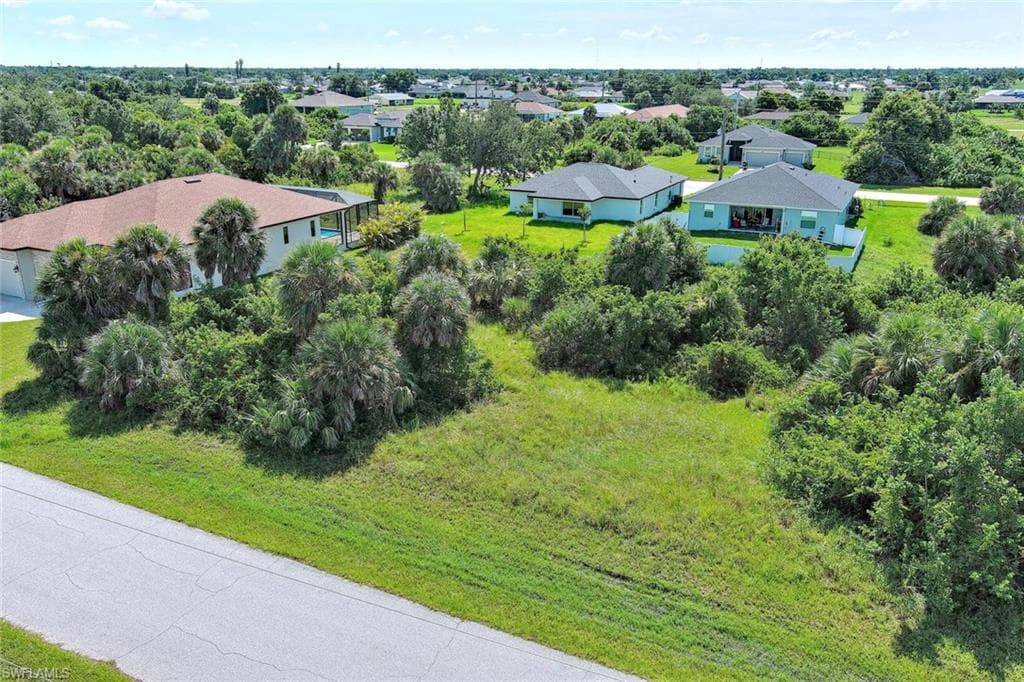 Aerial view of residential area featuring a tree filled landscape
