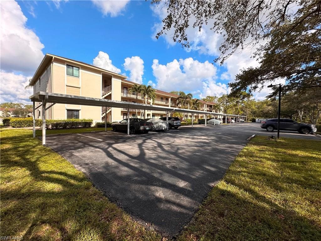 View of property with covered parking