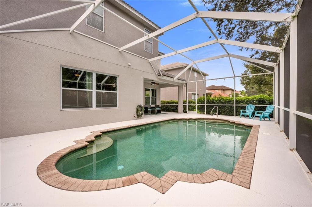Swimming pool with a patio, a sunroom, glass enclosure, and a ceiling fan