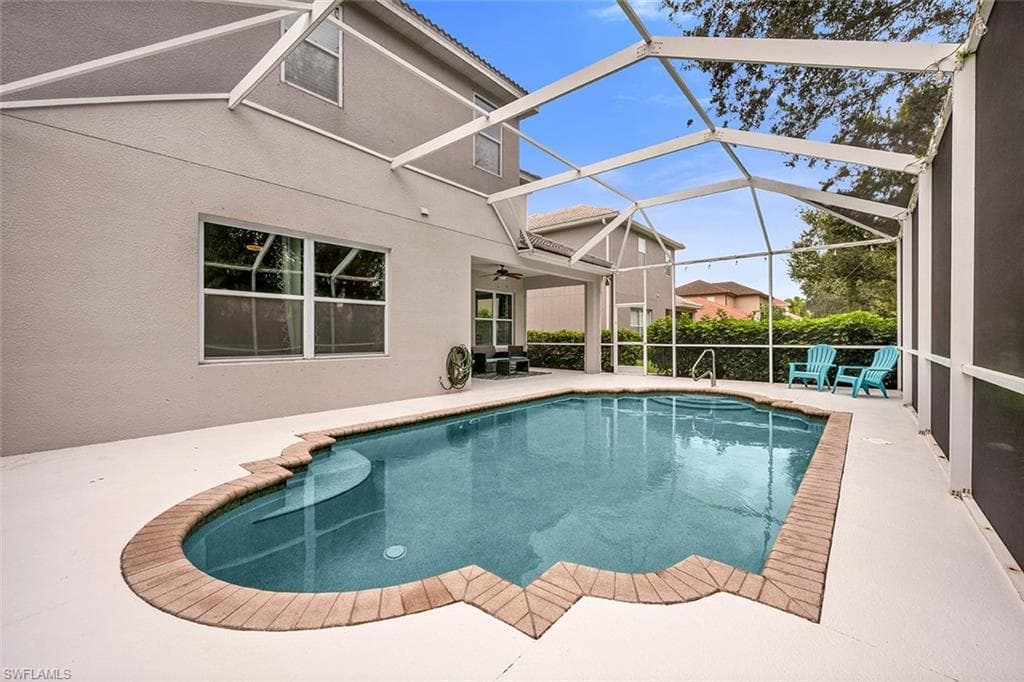 Swimming pool with a patio area, a sunroom, a lanai, and ceiling fan