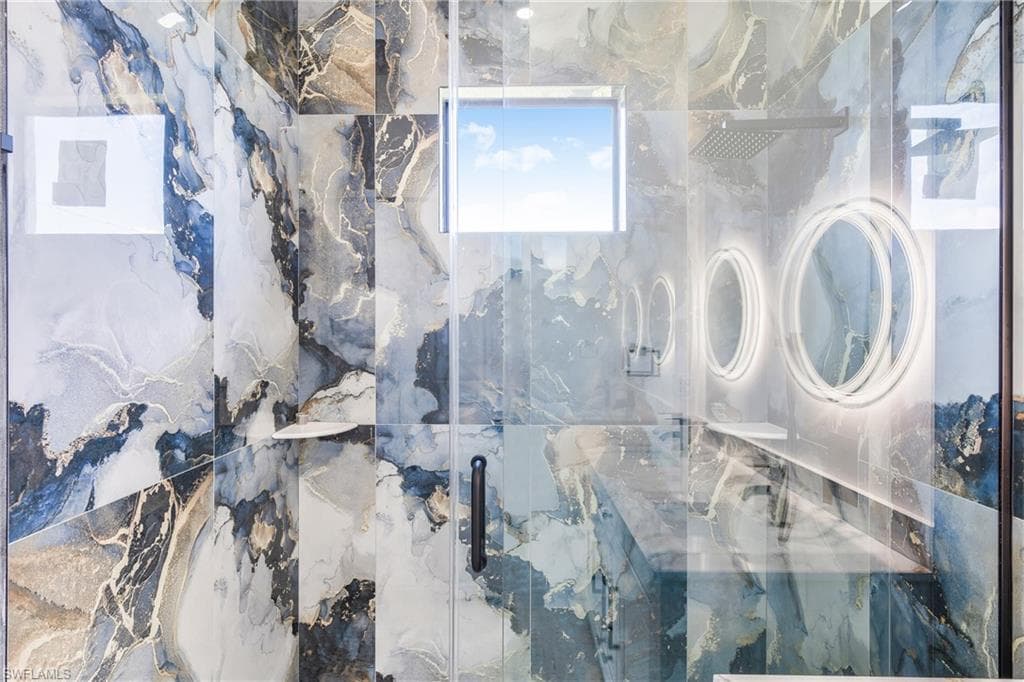 Full bathroom featuring a marble finish shower