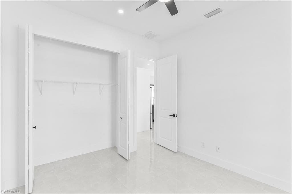 Unfurnished bedroom featuring ceiling fan, recessed lighting, a closet, and light tile patterned flooring